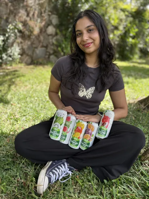 Holding all five Vinut juice flavours